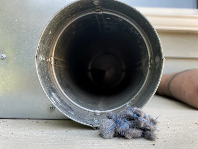 Plymouth Dryer Vent Cleaning technician using specialized equipment to clear severe dryer vent blockage in Plymouth